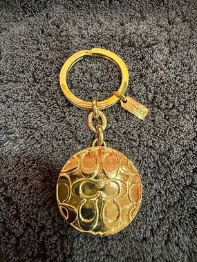 Coach Gold-Tone Locket Embossed Signature Round Keychain